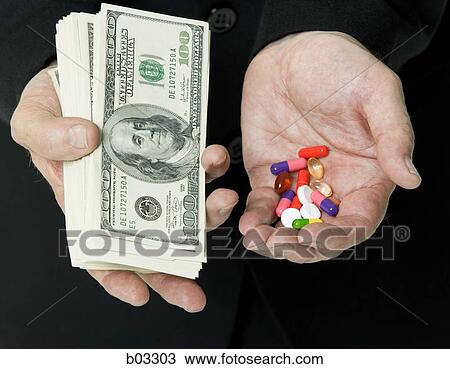 Hands holding US dollar banknotes and pills View Large Photo Image Stock Image - Hands holding US dollar banknotes and pills. Fotosearch