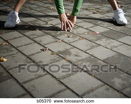 Jogger stretching hands and feet only View Large Photo Image Stock Image - Jogger stretching hands and feet only. Fotosearch