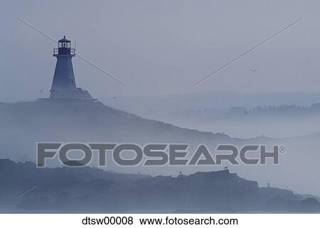 Lighthouse in fog with rock formations View Large Photo Image Stock Photo - Lighthouse in fog with rock formations. Fotosearch