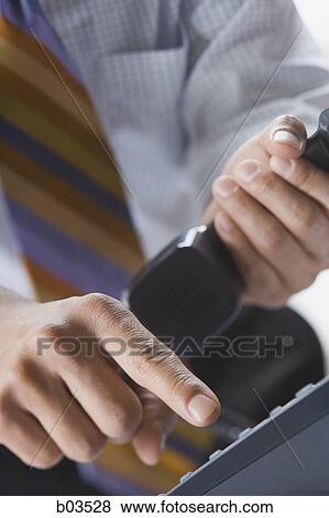 Stock Photo - Making a telephone call. Fotosearch