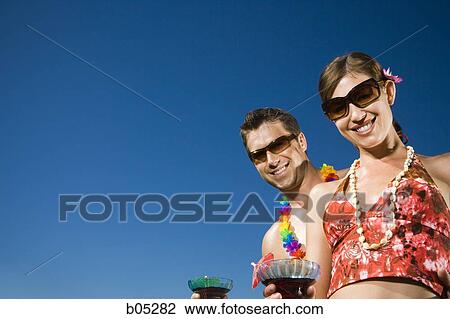 Male and female with cocktails outdoors View Large Photo Image Stock Image - Male and female with cocktails outdoors. Fotosearch