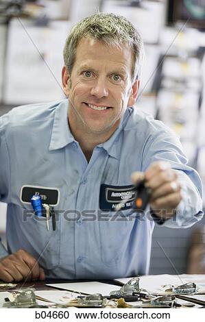 Male auto shop worker with key View Large Photo Image Stock Image - Male auto shop worker with key. Fotosearch