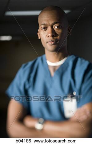 Male doctor with arms crossed View Large Photo Image Stock Photograph - Male doctor with arms crossed. Fotosearch