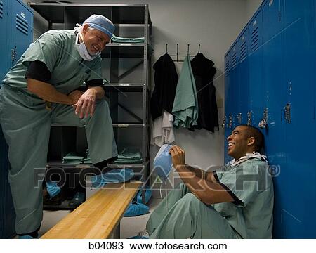 Male doctors in scrubs talking in locker room View Large Photo Image Stock Image - Male doctors in scrubs talking in locker room. Fotosearch