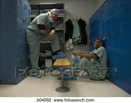 Male doctors in scrubs talking View Large Photo Image Stock Image - Male doctors in scrubs talking. Fotosearch