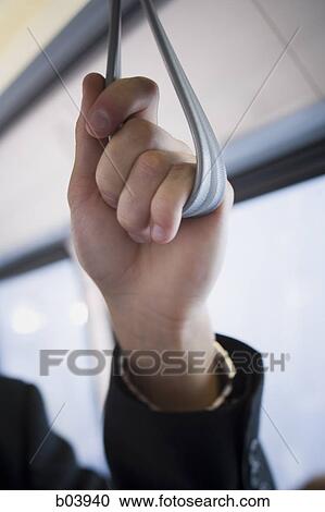 Male holding handle in bus or subway View Large Photo Image Stock Image - Male holding handle in bus or subway. Fotosearch
