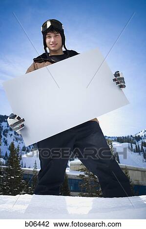 Male in the snow with a blank sign View Large Photo Image Stock Image - Male in the snow with a blank sign. Fotosearch