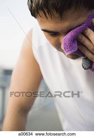 Male jogger drying sweat View Large Photo Image Picture - Male jogger drying sweat. Fotosearch