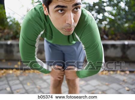 Picture - Male jogger resting. Fotosearch