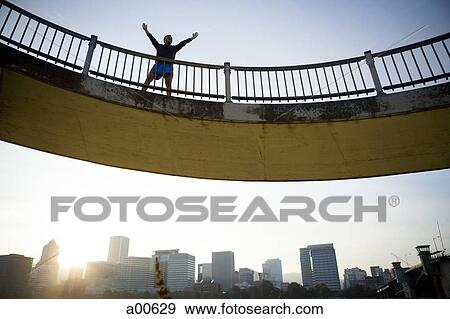 Male jogger standing on bridge View Large Photo Image Stock Photo - Male jogger standing on bridge. Fotosearch