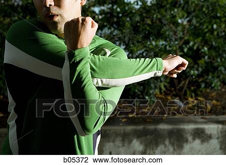 Male jogger stretching arms View Large Photo Image Stock Image - Male jogger stretching arms. Fotosearch