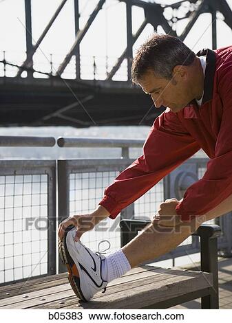 Male jogger stretching View Large Photo Image Stock Image - Male jogger stretching. Fotosearch