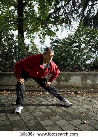 Male jogger stretching View Large Photo Image Stock Photo - Male jogger stretching. Fotosearch