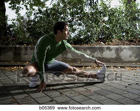 Male jogger stretching View Large Photo Image Stock Photo - Male jogger stretching. Fotosearch