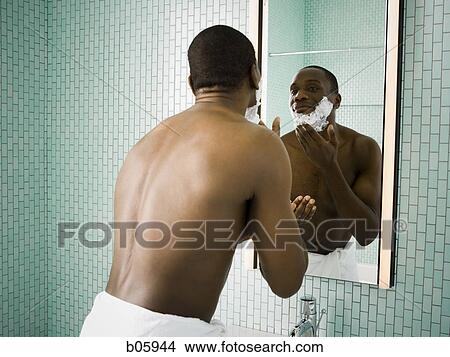 Male putting shaving cream on face View Large Photo Image Picture - Male putting shaving cream on face. Fotosearch