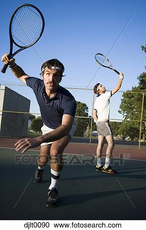 Stock Image - Male Tennis Players on the court. Fotosearch
