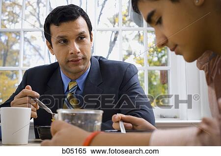 Man and boy at breakfast table displeased View Large Photo Image Stock Photography - Man and boy at breakfast table displeased. Fotosearch