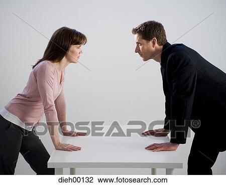 Stock Image - Man and woman at a table. Fotosearch