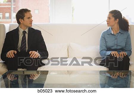 Man and woman at each end of sofa View Large Photo Image Stock Image - Man and woman at each end of sofa. Fotosearch