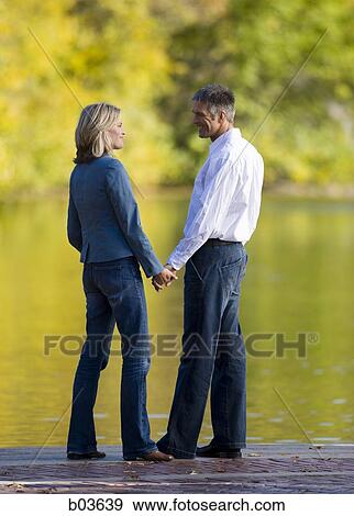 Man and woman holding hands View Large Photo Image Stock Photo - Man and woman holding hands. Fotosearch