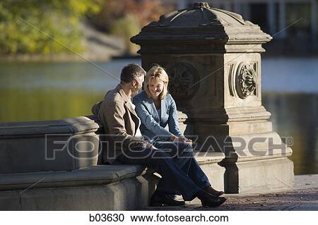 Stock Image - Man and woman in park. Fotosearch