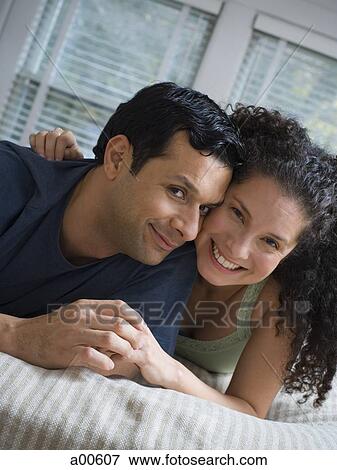 Man and woman on bed cuddling View Large Photo Image Stock Photo - Man and woman on bed cuddling. Fotosearch