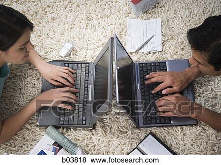 Man and woman on carpet with laptops View Large Photo Image Stock Photo - Man and woman on carpet with laptops. Fotosearch