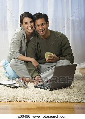 Man and woman on carpet with laptops View Large Photo Image Stock Photograph - Man and woman on carpet with laptops. Fotosearch