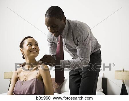 Man doing up a woman's necklace clasp View Large Photo Image Stock Image - Man doing up a woman's necklace clasp. Fotosearch