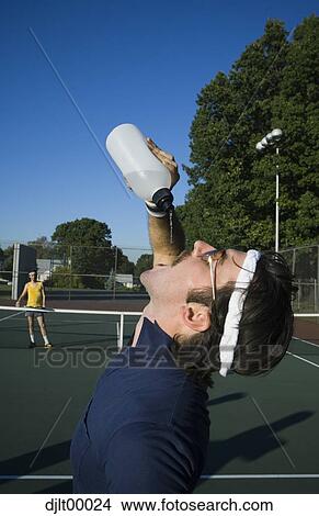 Picture - Man drinking water. Fotosearch