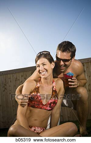Man embracing woman in bikini smiling View Large Photo Image Stock Photo - Man embracing woman in bikini smiling. Fotosearch