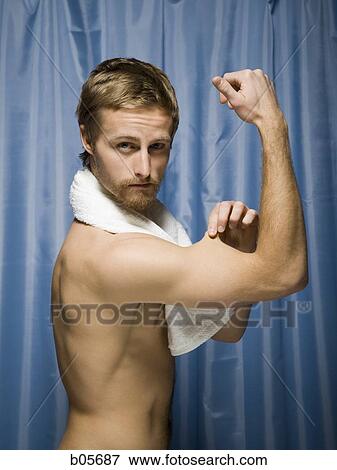 Man flexing muscles View Large Photo Image Stock Photo - Man flexing muscles. Fotosearch