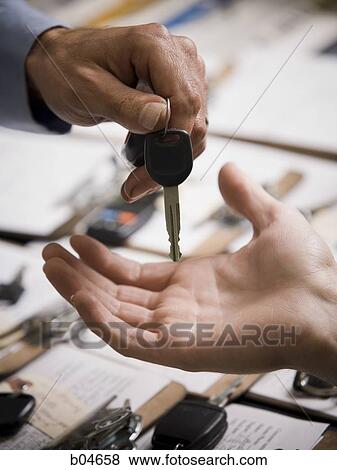 Man handing car keys to woman View Large Photo Image Stock Photo - Man handing car keys to woman. Fotosearch