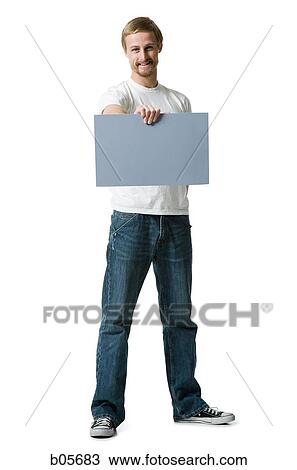 Stock Image - Man holding a blank sign. Fotosearch