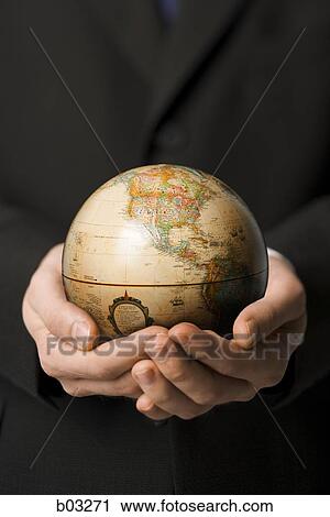 Stock Image - Man holding globe. Fotosearch