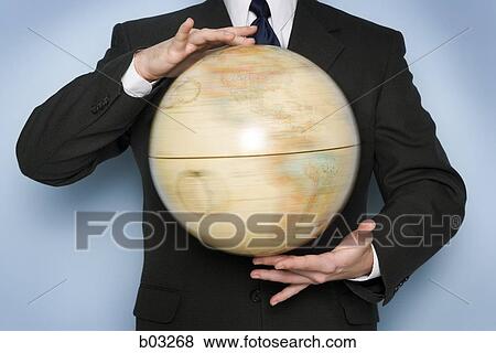 Stock Photo - Man holding globe. Fotosearch