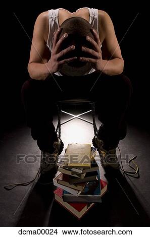 Picture - Man holding shaved head. Fotosearch