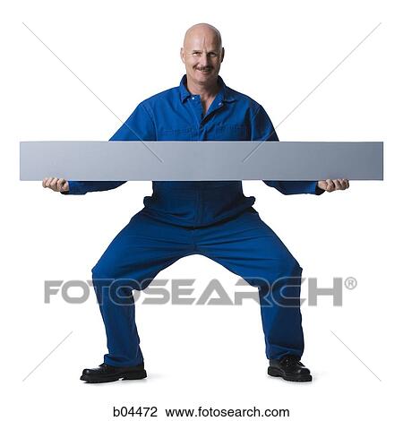 Man in overalls standing with blank sign View Large Photo Image Stock Image - Man in overalls standing with blank sign. Fotosearch