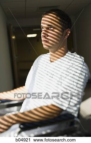 Man in wheelchair sitting in corridor with horizontal blind shadows View Large Photo Image Stock Image - Man in wheelchair sitting in corridor with horizontal blind shadows. Fotosearch