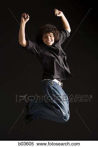 Stock Photography - Man jumping and smiling. Fotosearch