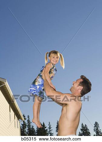 Man lifting girl with pigtails View Large Photo Image Stock Photography - Man lifting girl with pigtails. Fotosearch