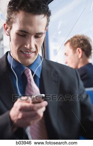 Man listening to iPod in bus or subway View Large Photo Image Stock Photograph - Man listening to iPod in bus or subway. Fotosearch