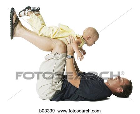 Man on floor playing with child View Large Photo Image Stock Photo - Man on floor playing with child. Fotosearch