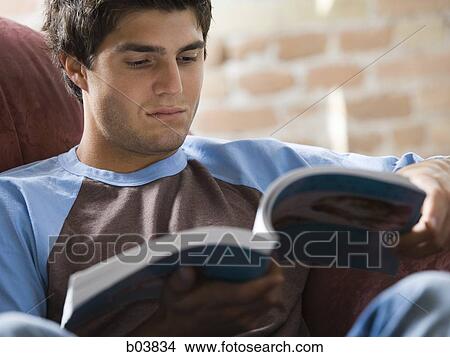 Man on sofa reading View Large Photo Image Picture - Man on sofa reading. Fotosearch