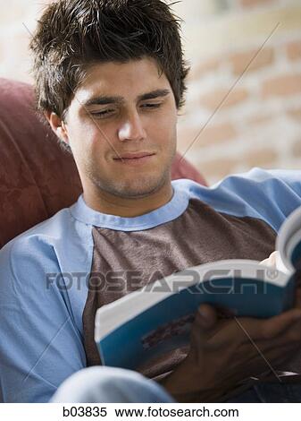 Man on sofa reading View Large Photo Image Stock Photography - Man on sofa reading. Fotosearch