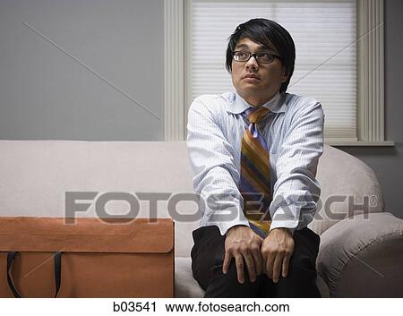 Man on sofa with portfolio View Large Photo Image Stock Image - Man on sofa with portfolio. Fotosearch