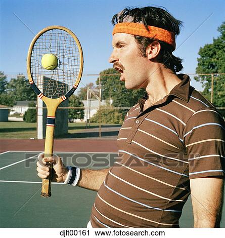 Stock Image - Man playing tennis. Fotosearch