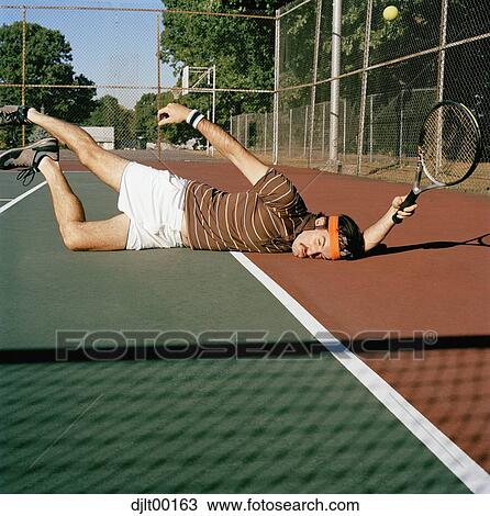 Stock Image - Man playing tennis. Fotosearch