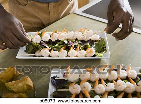 Man preparing appetizers View Large Photo Image Stock Image - Man preparing appetizers. Fotosearch