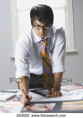 Stock Image - Man preparing for presentation. Fotosearch